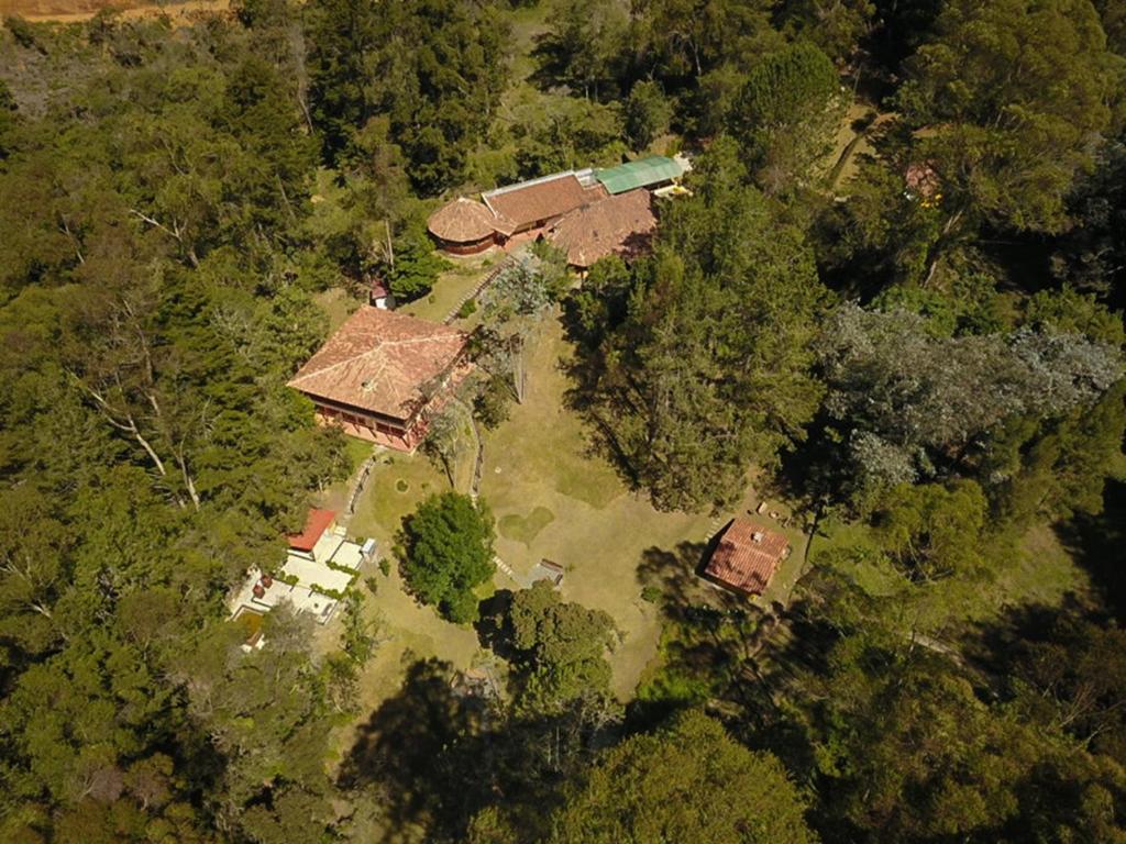 an overhead view of a house in the forest at Olimpo Interior in Santa Elena
