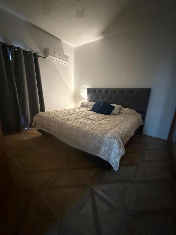 a bedroom with a bed in a room with curtains at Richard House in Villa Dolores