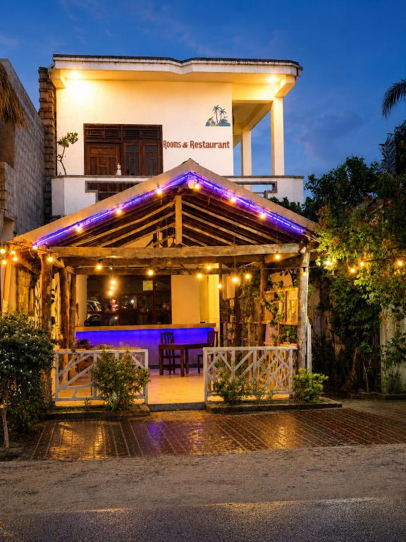 a building with a lit up facade at night at Yellow bay inn in Arugam Bay