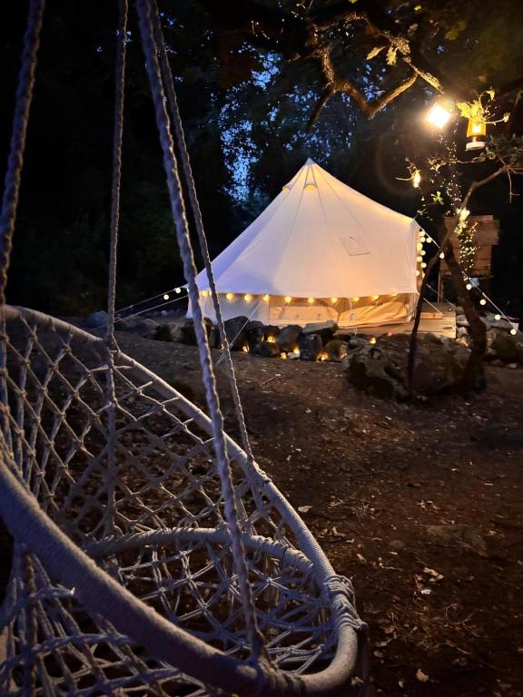 a white tent in the dark with a white tent at S'incantu in Burgos