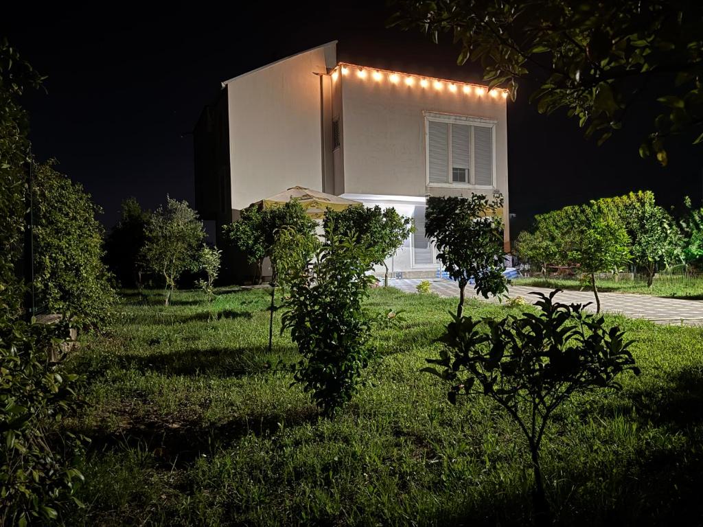 a house with lights on the side of it at night at Villa 6C Sunny Nest in Draç