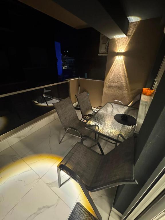 a room with two chairs and a table and a lamp at Premium Studio Family in Paralia Katerinis
