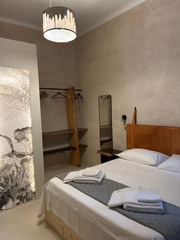 a bedroom with a bed with towels on it at Casa Citta in Brescia