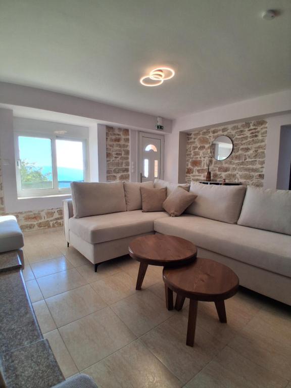 a living room with a couch and a table at Οcalia Apartment in Petrokhórion