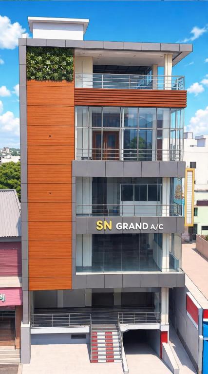 a building with a samsung grand ape sign on it at SN Grand lodge AC in Badvel