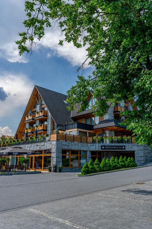 a large building with a building at Hotel Litworowy Staw in Białka Tatrzańska
