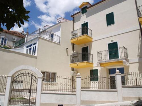 a large white building with balconies on the side of it at Apartmani Paula in Makarska