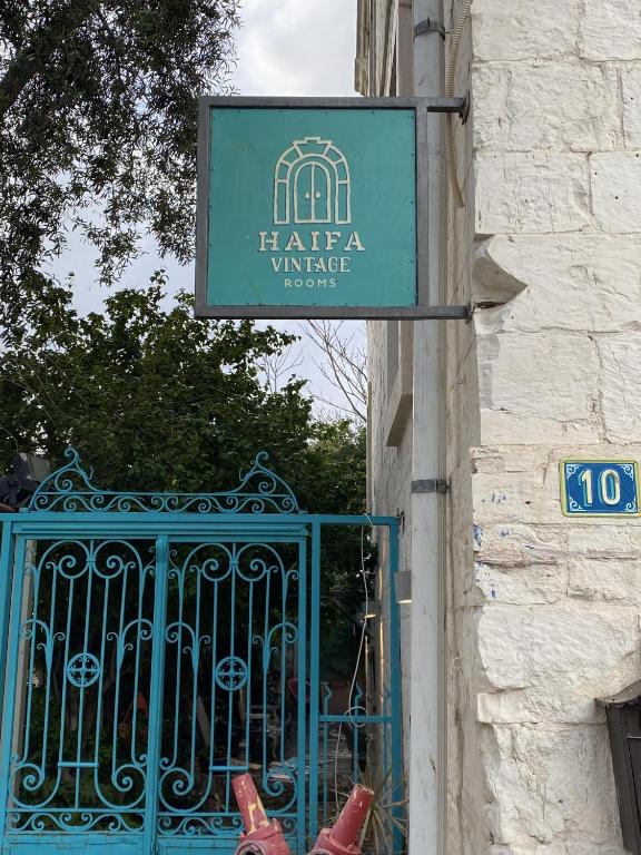 a sign on the side of a building with a gate at Haifa Vintage Studios in Haifa