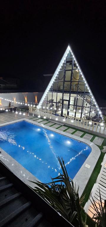 a large swimming pool in front of a building at night at Dreamvilla aframe in Gabala