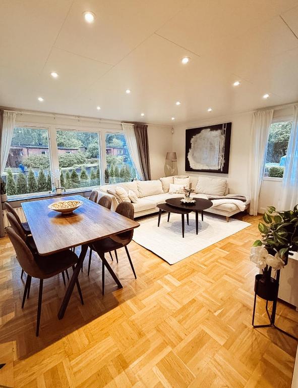 a living room with a table and a couch at Villa lugn och ro in Gustavsberg