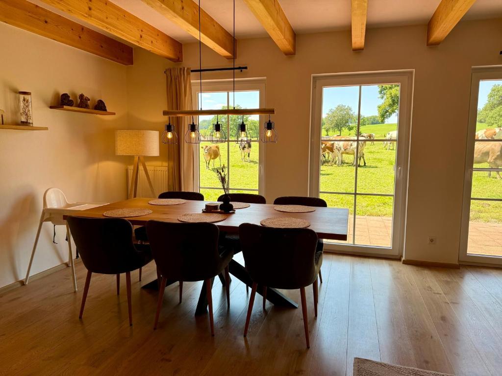 a dining room with a wooden table and chairs at Haus Muhblick in Schmallenberg