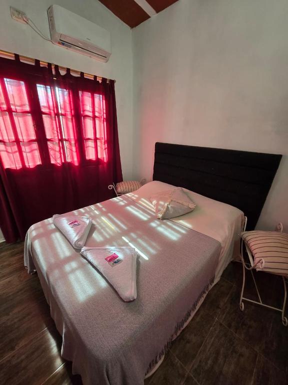 a bedroom with a bed with two towels on it at La Chiquitita apart in San Fernando del Valle de Catamarca