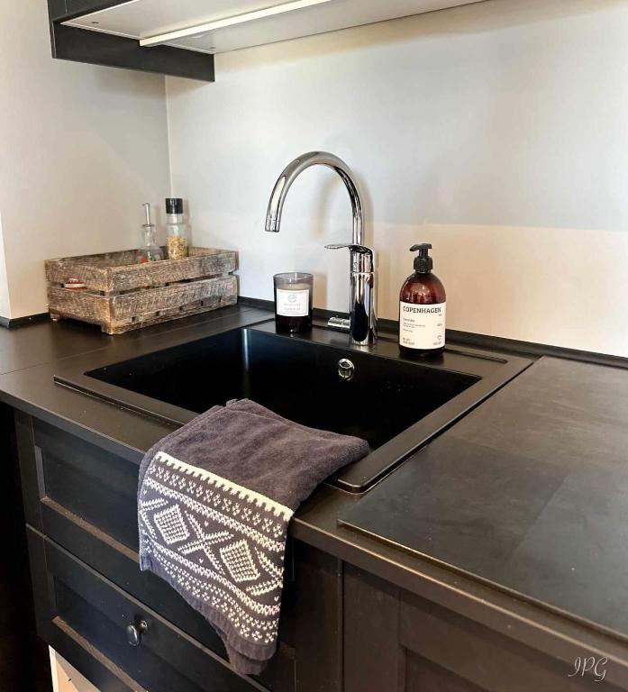 a kitchen with a sink and a counter top at Kikuttoppen in Hol