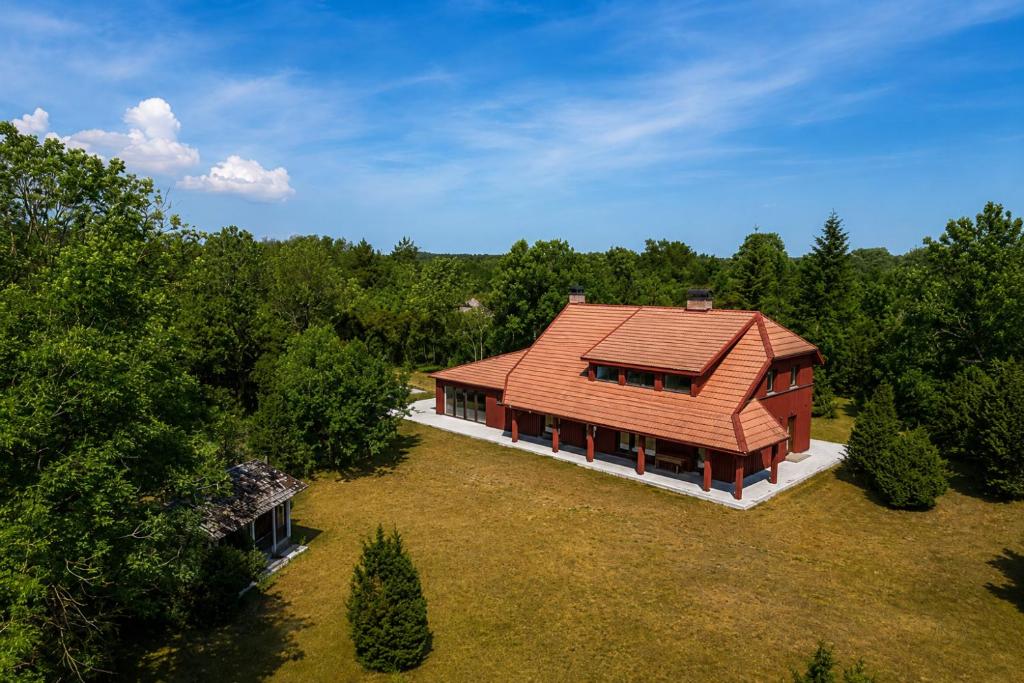 an overhead view of a house in the woods at Suur ja Hubane maja, Saaremaal in Saareküla