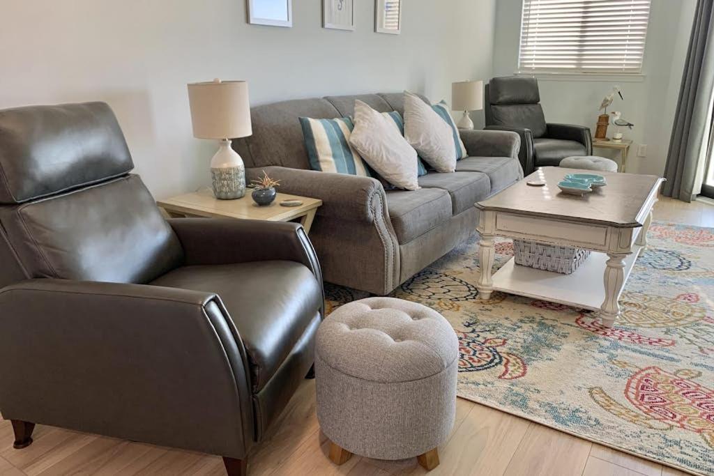 a living room with a couch and chairs and a table at Bay Creek Villa - 304 in Edisto Island