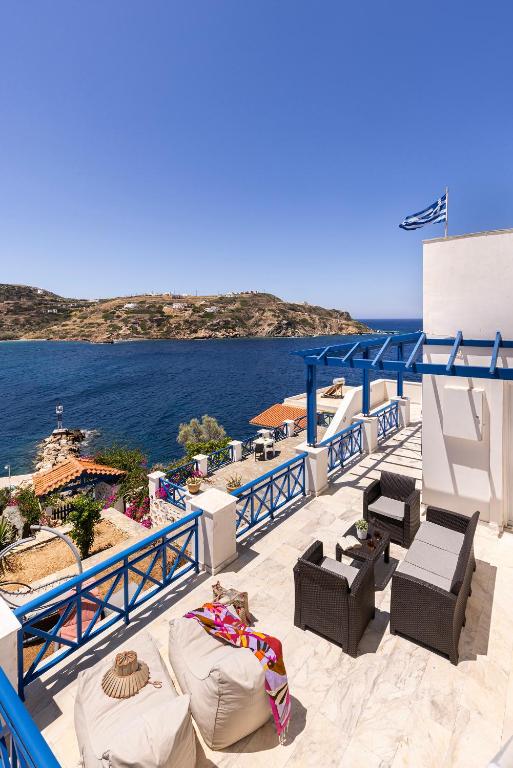 a balcony with chairs and a view of the ocean at Syros Private House with superb sea view in Kini