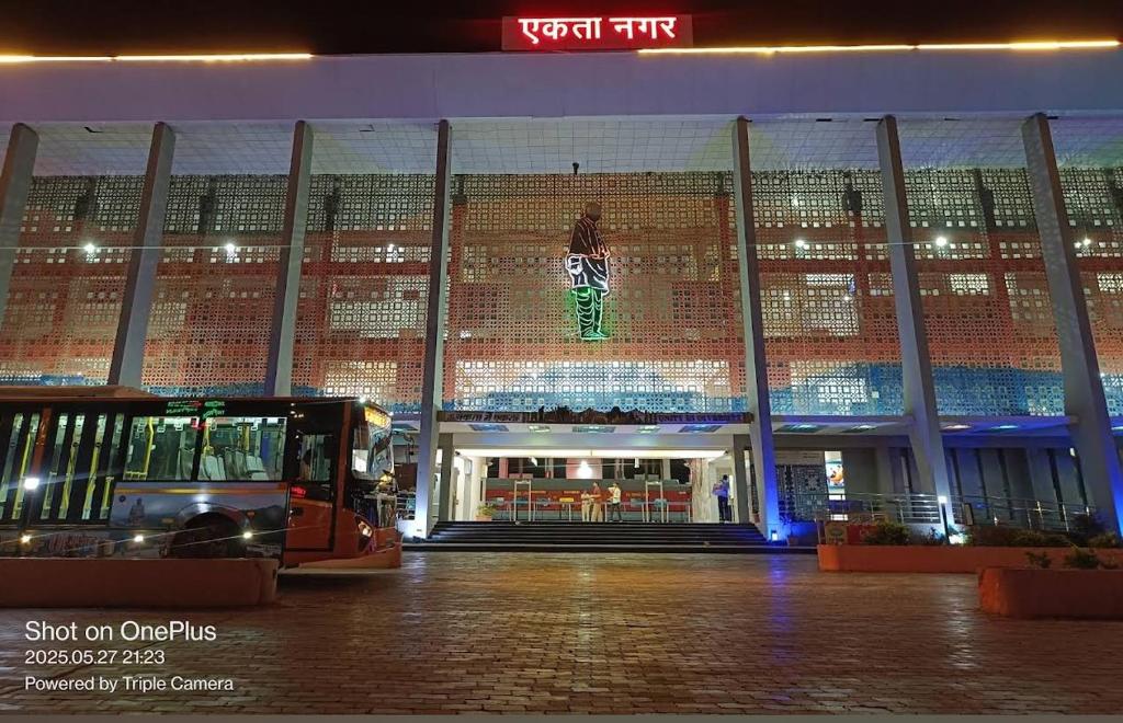 a large building with a large display in front of it at Rail connect hotel statue of unity in Kevadia