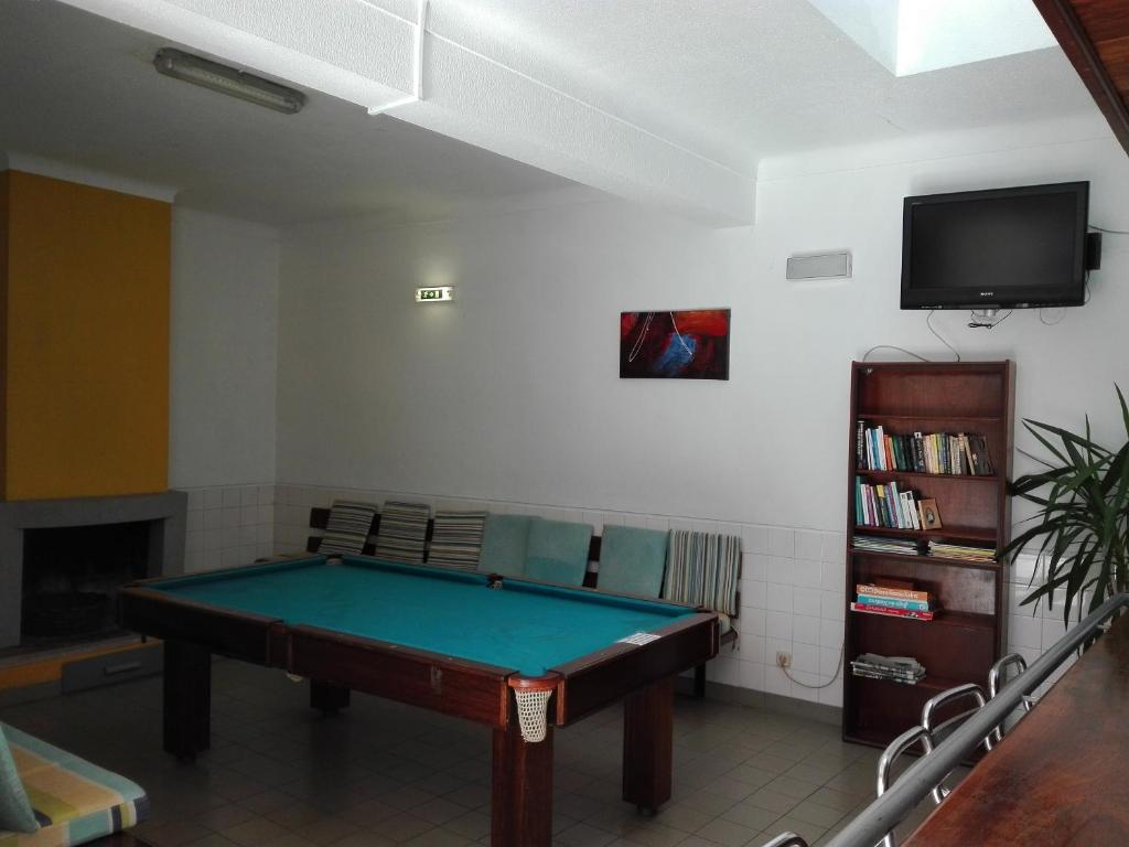 a living room with a pool table and a tv at HI Lagos - Pousada de Juventude in Lagos