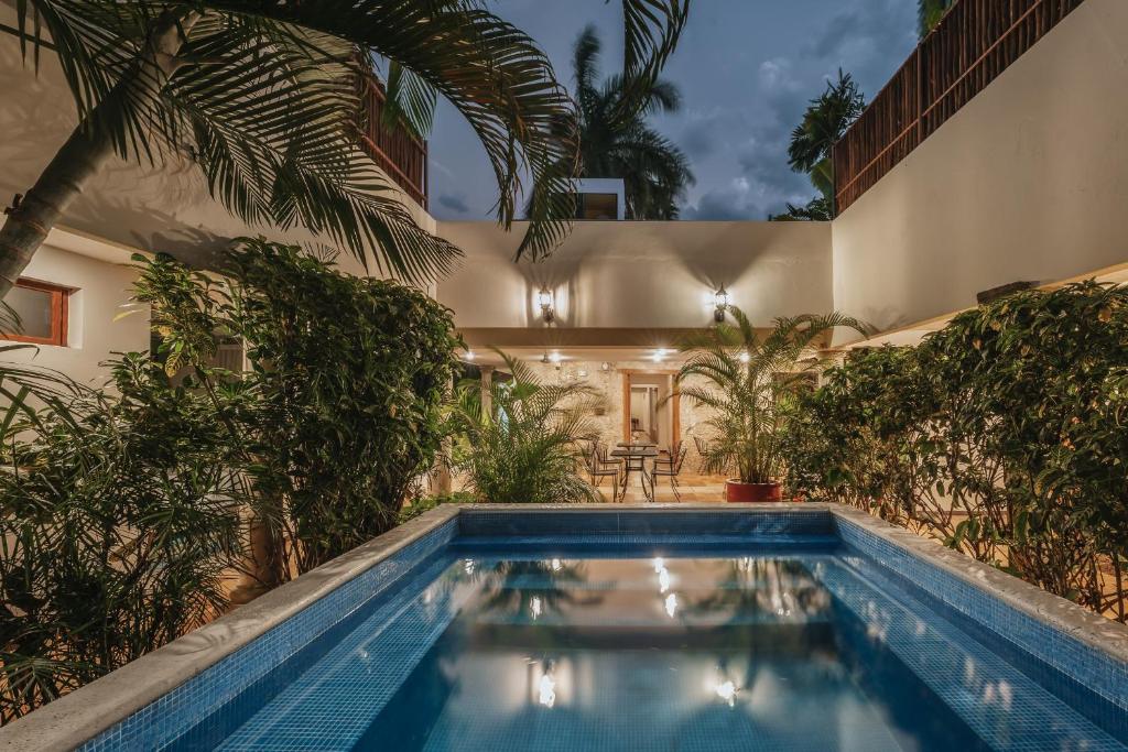 a swimming pool in the backyard of a house at Casa Aura Hotel, Mérida in Mérida