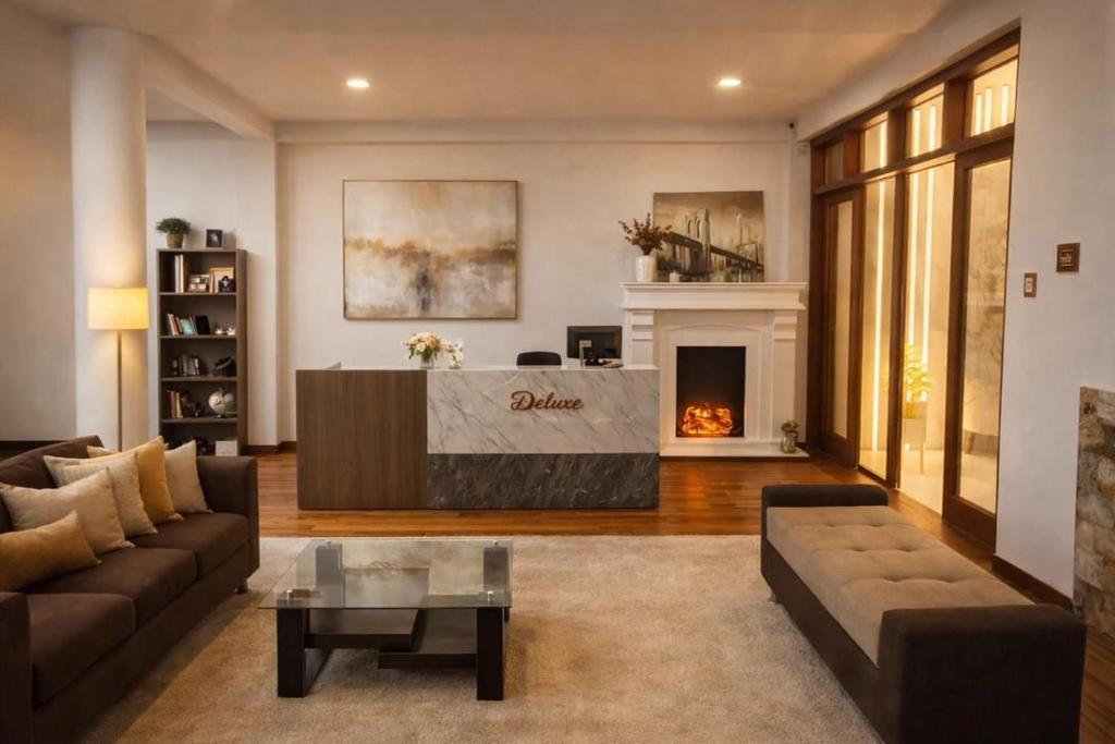 a living room with a couch and a fireplace at Casa Deluxe Hotel Talara in Talara