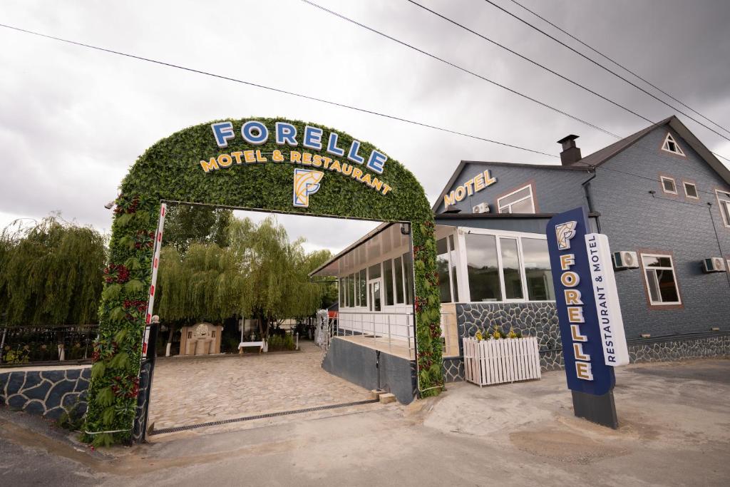a forgettable worlds miracle sign in front of a building at Forelle Restaurant & Motel in Çuxuryurd
