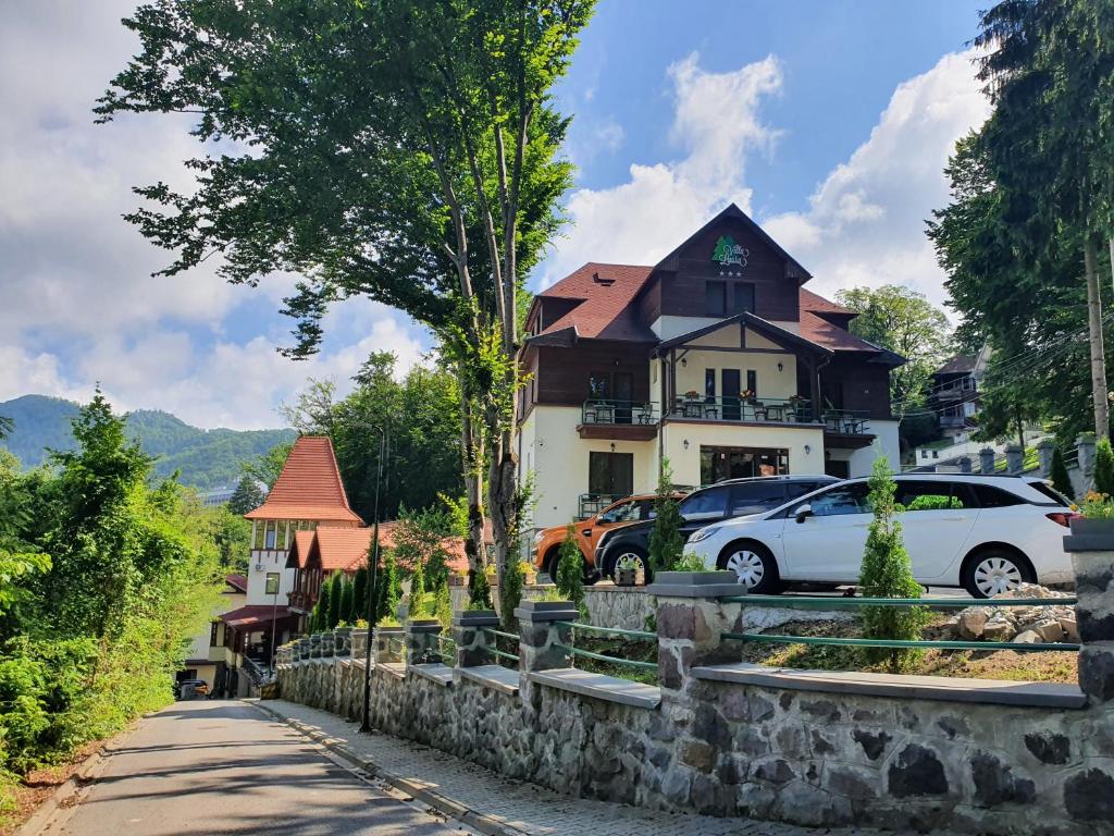 a white car parked in front of a house at Vila Laura 1 in Sovata