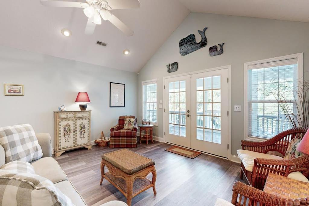 a living room with a couch and a table at Pompano End in Edisto Island