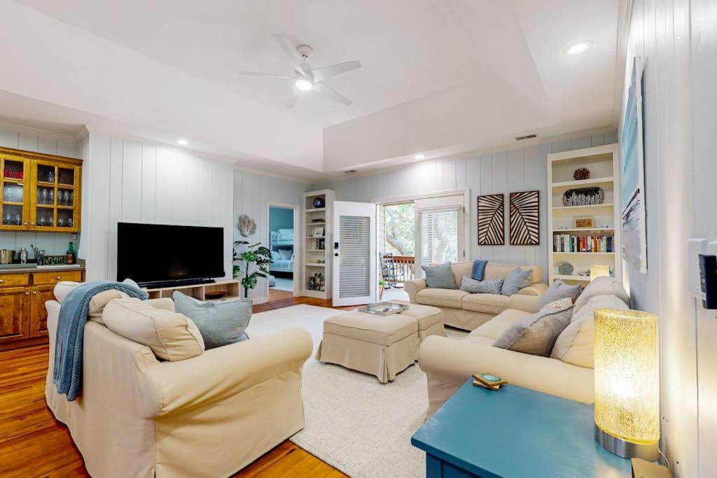 a living room with two couches and a tv at Natural Wonder in Edisto Island