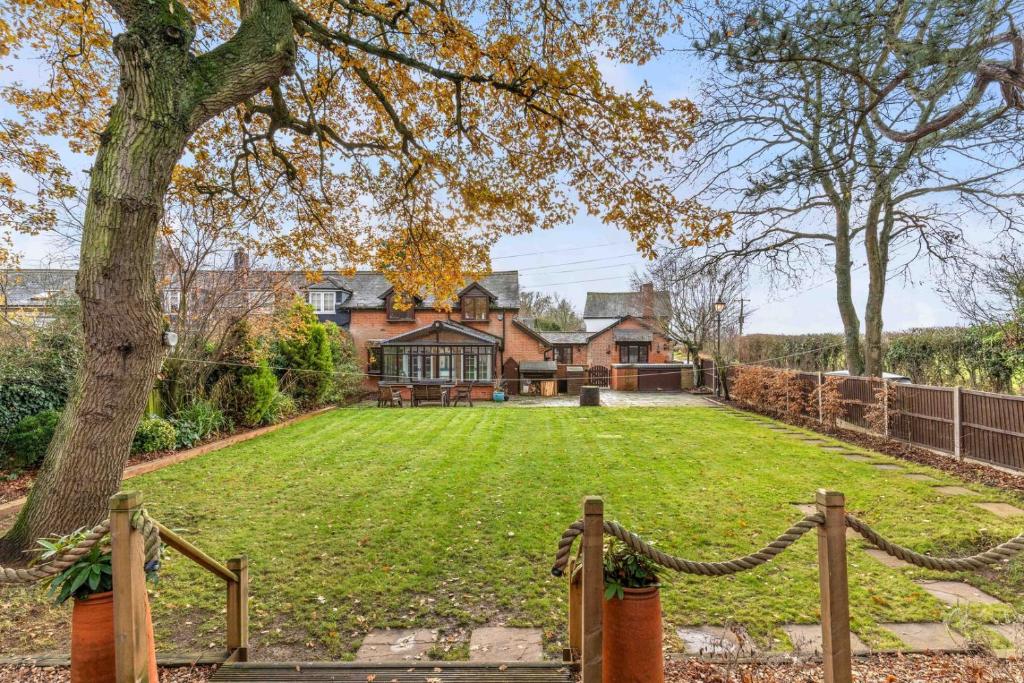 a house with a large yard with a fence at Countryside Studio with Private Sauna in Sacomb