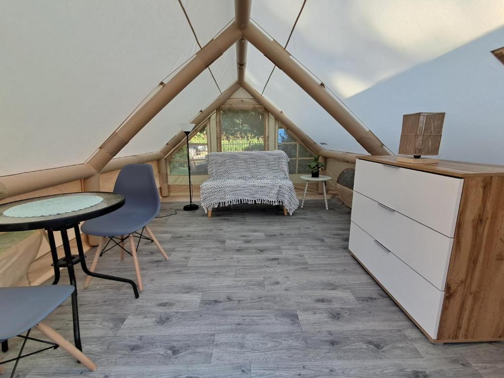a room with a table and chairs in a tent at Namiot glampingowy u Kasi in Pojezierze