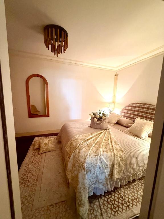 a bedroom with a bed and a mirror at Maison Moena Dolomites in Moena