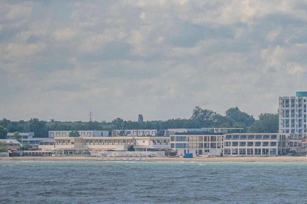 a large building on the shore of a body of water at Palace Resort in Venus