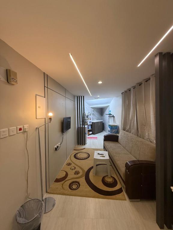 a living room with a couch and a table at ستديو in Al Baha