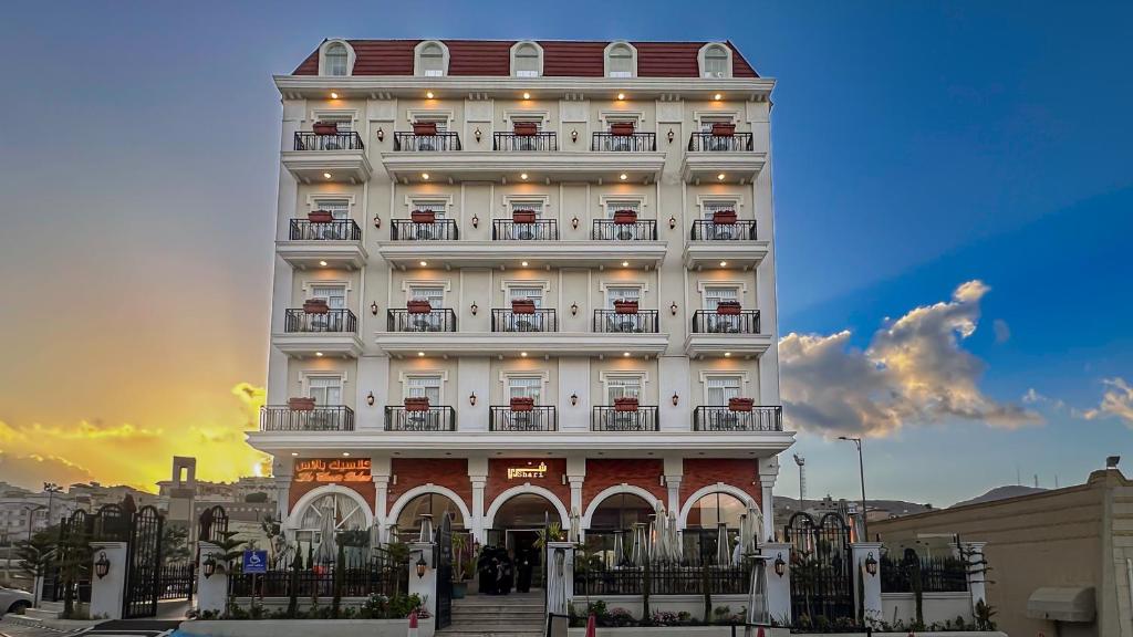 a tall white building with balconies on it at The Classic Palace in Abha