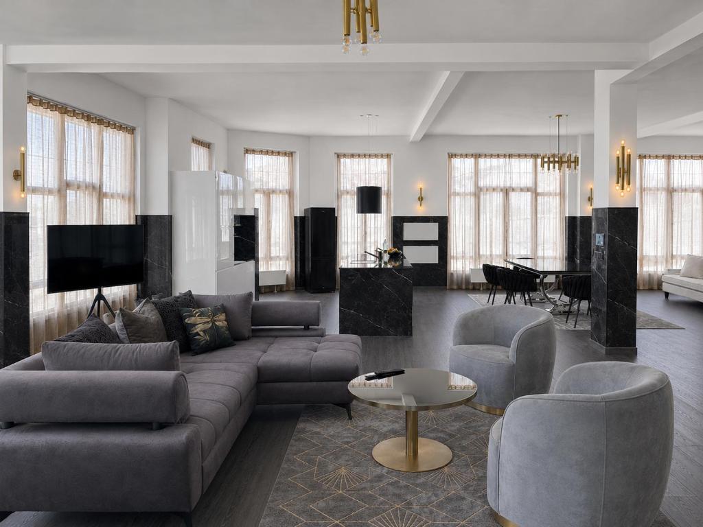 a living room with a couch and chairs and a table at White House Meerane - Loft Sky in Meerane