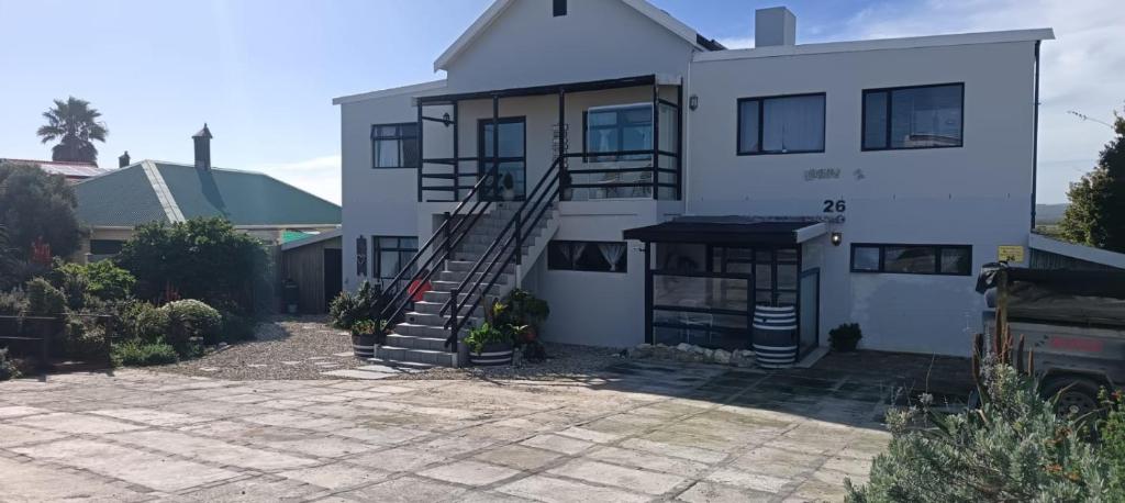 a white house with a staircase in front of it at Intimi2 in Yzerfontein