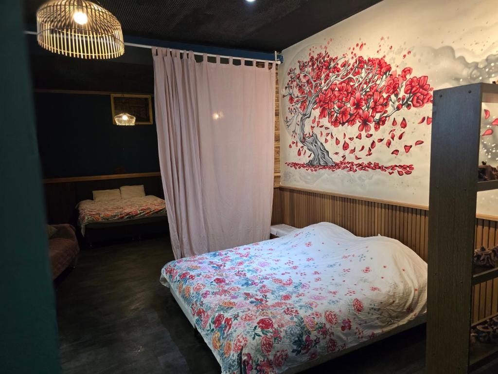 a bedroom with a bed and a painting on the wall at kyoto b&b in Ostend