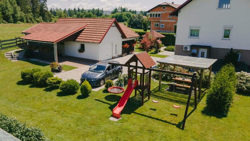 an aerial view of a house with a playground at Soba i Apartman Đula in Ogulin