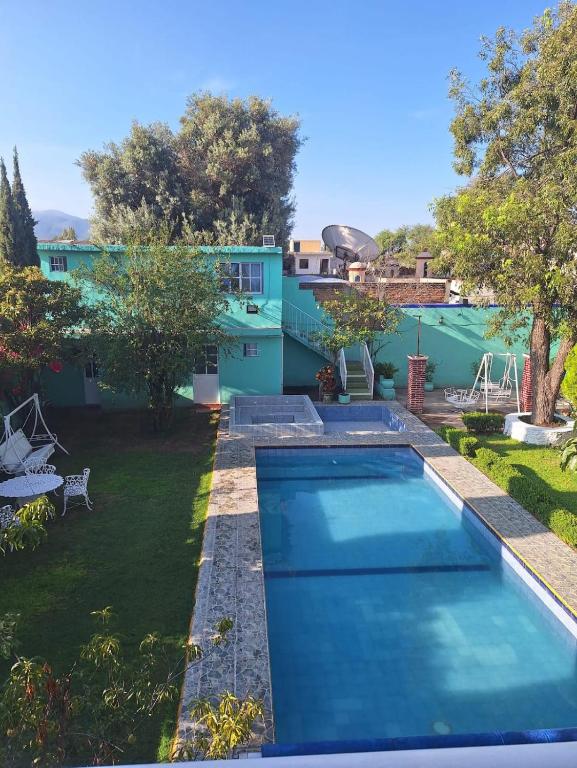 a swimming pool in the backyard of a house at Hotel Elohim Tequis in Tequisquiapan