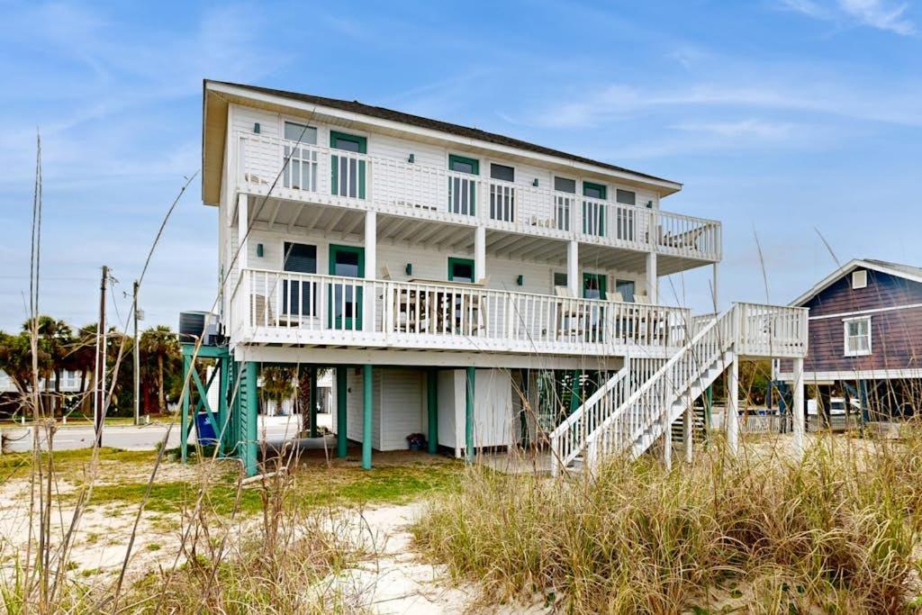 a house on the beach with a balcony and stairs at KC's Seaside Sanctuary in Edisto Island