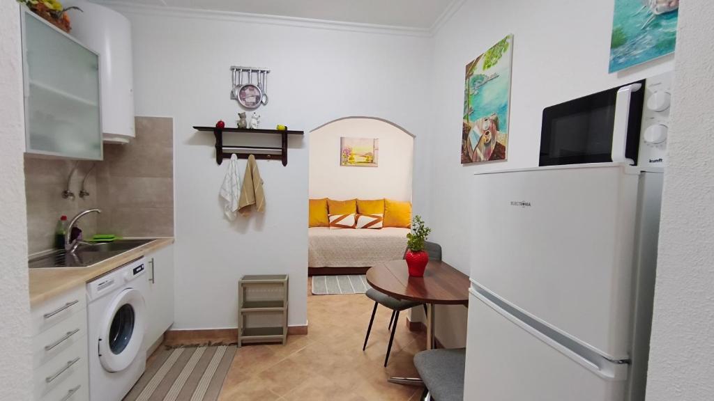 a small kitchen with a sink and a refrigerator at Casa Lotus in Aljezur