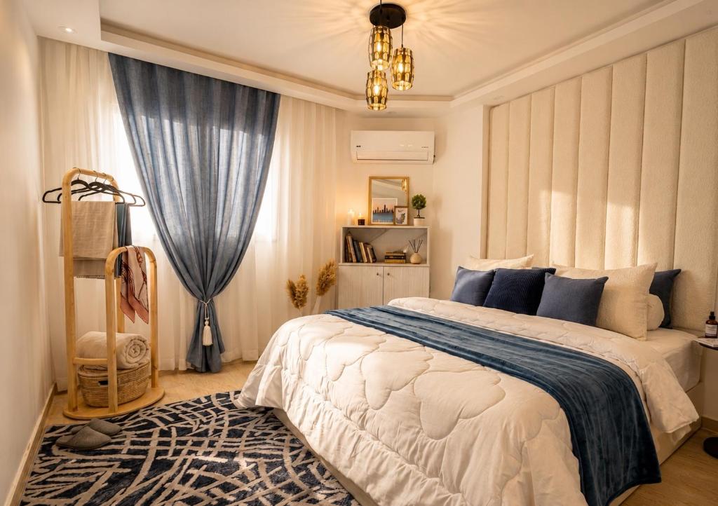 a bedroom with a large bed and a chandelier at Smart Home near beach and pool in Sharm El Sheikh
