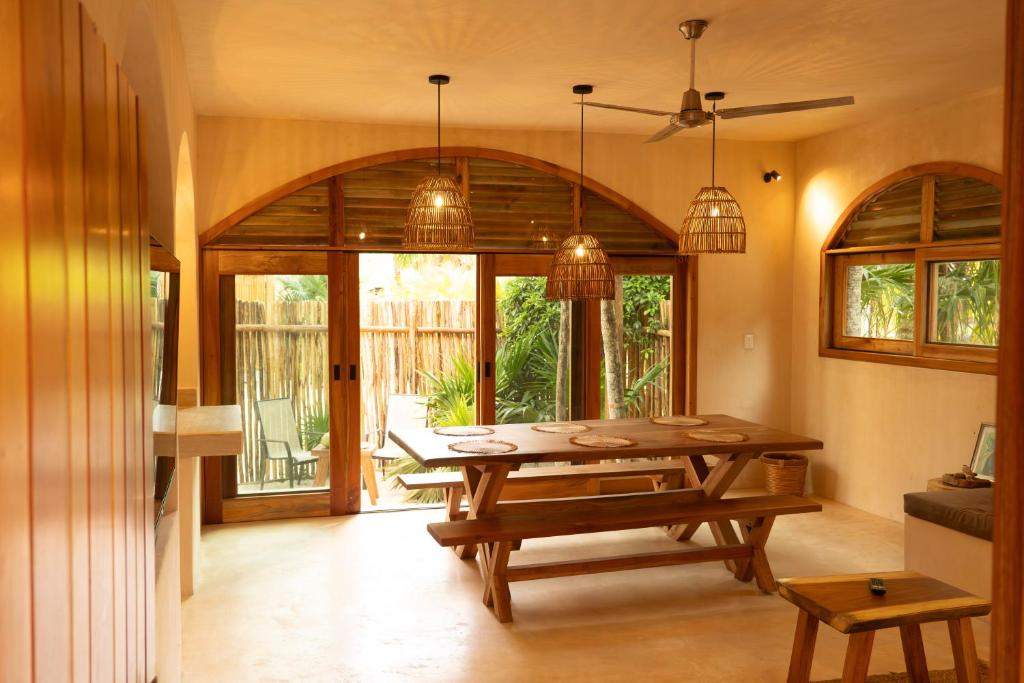 a dining room with a wooden table and glass doors at Villa Hydra Private Villa with Rooftop Pool in El Cuyo
