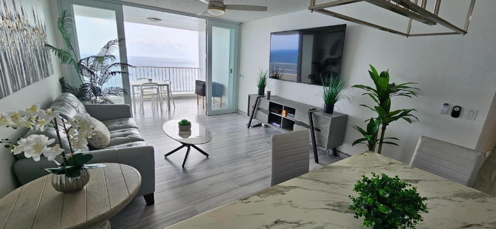 a living room with a couch and a table at Oceanfront 3-bedroom Sub-Penthouse in Luquillo PR in Luquillo