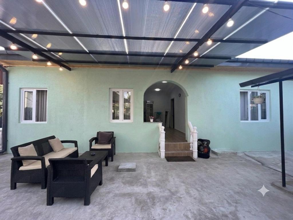a living room with chairs and a ceiling with lights at Maya Seaside Ureki in Ureki