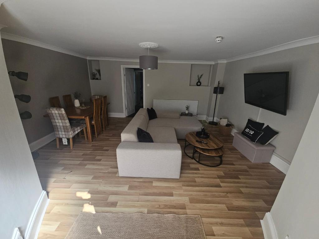 a living room with a white couch and a tv at Close to amenities in Weston-super-Mare
