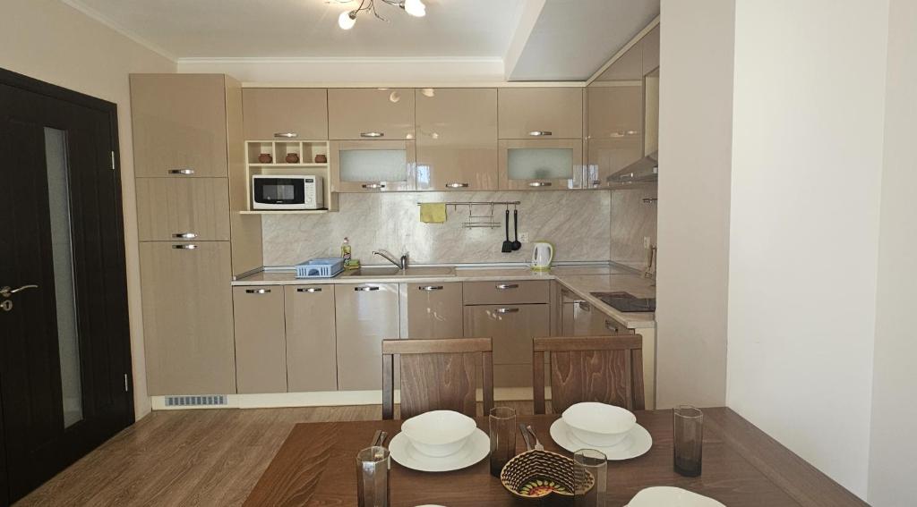 a kitchen with two chairs and a table in it at Sun Sea App in Shkorpilovtsi