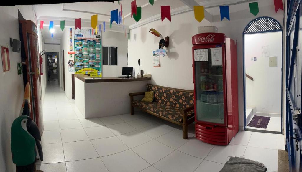 a room with a coca cola machine in a store at Pousada Dipajuçara in Maceió