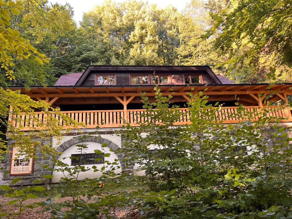a house with a deck on top of a building at Chata Salamandra in Michalovce
