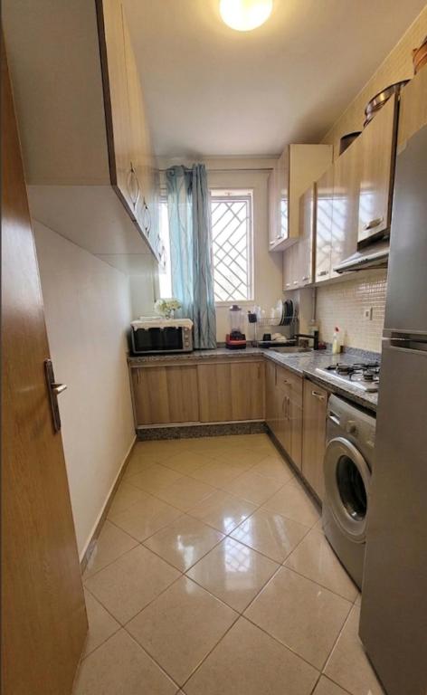 a kitchen with a washer and a dishwasher at Résidence Erahha in Agadir